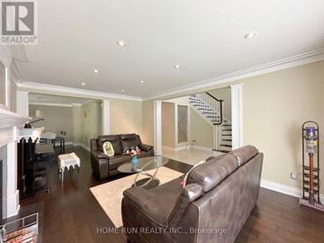 Ottawa apartment for rent - A living room with a brown leather couch and a glass coffee table.