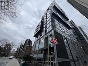 Toronto (Church-Yonge Corridor) condo for rent - A tall building with a red and white logo on the front.