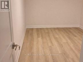 Toronto (Milliken) apartment for rent - A room with wooden flooring and a door with a key in it.