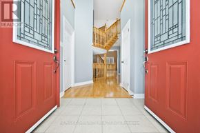 Midland apartment for rent - A hallway with red doors and a wooden staircase.
