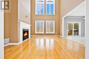 Midland apartment for rent - A spacious room with a fireplace and large windows.