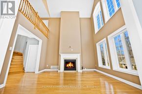 Midland apartment for rent - A spacious living room with a fireplace and a staircase.