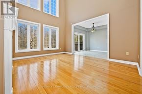Midland apartment for rent - A spacious room with wooden floors and a large mirror on the wall.
