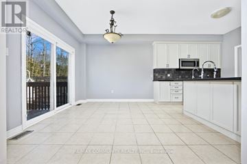 Midland apartment for rent - A spacious kitchen with white cabinets and a black countertop.