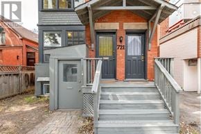 Ottawa triplex for rent - A house with a grey front door and a black front door.