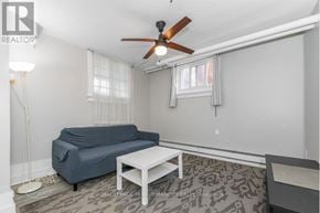Ottawa triplex for rent - A living room with a blue couch and a white coffee table.