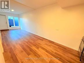 Toronto (North Riverdale) multi-family for rent - A room with wooden flooring and a window.