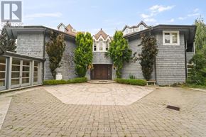 Caledon apartment for rent - A grey house with a brick driveway in front.
