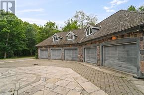 Caledon apartment for rent - A house with a brick wall and a grey garage door is for sale.