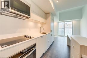Burlington condo for rent - A modern kitchen with white cabinets and stainless steel appliances.
