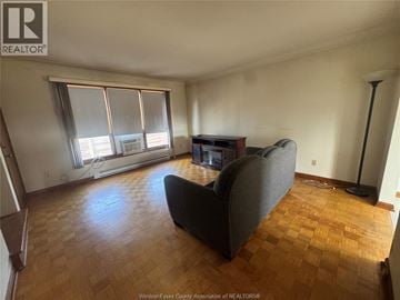 Windsor townhouse for rent - A living room with a grey couch and wooden floors.