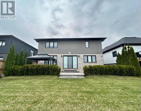 Fort Erie (Black Creek) apartment for rent - A modern house with a well-maintained lawn in front.