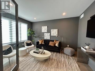 Fort Erie (Black Creek) apartment for rent - A living room with a black couch and a coffee table.