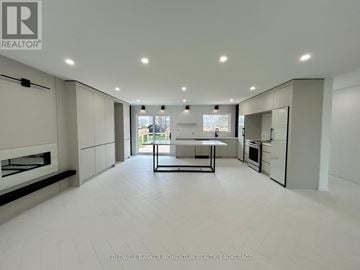 Niagara-On-The-Lake (Rural) apartment for rent - A modern kitchen with white cabinets and a central island.