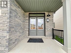 Welland apartment for rent - A grey door with a glass window is on a stone wall.