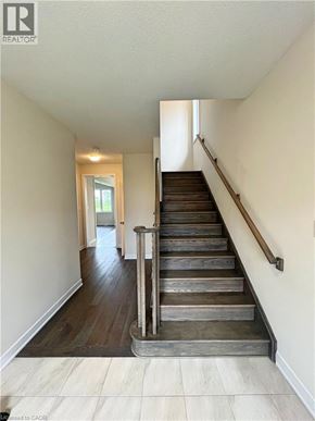 Welland apartment for rent - A staircase with wooden steps and a metal handrail.
