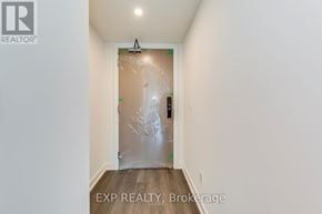 Burlington (Brant) condo for rent - A room with a door covered in plastic and a REALTOR® logo on the wall.
