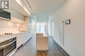 Burlington (Brant) condo for rent - A kitchen with white cabinets and a wooden island.