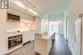 Burlington (Brant) condo for rent - A kitchen with white cabinets and appliances in a modern apartment.