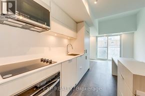 Burlington (Brant) condo for rent - A modern kitchen with white cabinets and stainless steel appliances.