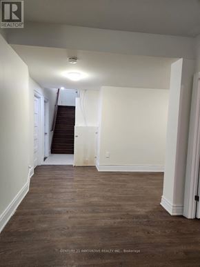 Toronto (Scarborough Village) apartment for rent - A hallway with wood floors and white walls.