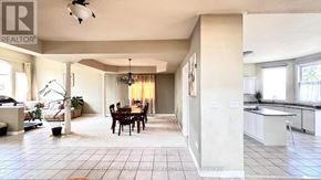 Markham (Rouge Fairways) apartment for rent - A well-lit, spacious kitchen and dining area with a large island and a dining table with chairs.