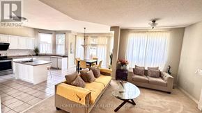 Markham (Rouge Fairways) apartment for rent - A living room with a yellow couch and a glass coffee table.