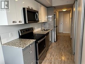 Waterloo condo for rent - A kitchen with a granite countertop and stainless steel appliances.