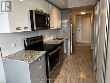 Waterloo condo for rent - A kitchen with a granite countertop and stainless steel appliances.