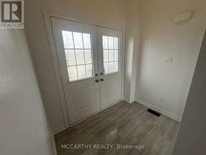 Southgate apartment for rent - A room with a white door and a window with blinds.