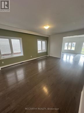Southgate apartment for rent - A room with wooden floors and green walls.