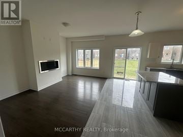 Southgate apartment for rent - A spacious living room with a television and sliding glass doors leading to a backyard.