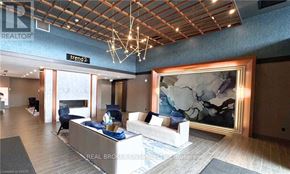 Hamilton (Waterdown) condo for rent - A living room with a large painting on the wall and a sign that says "Trend 2".