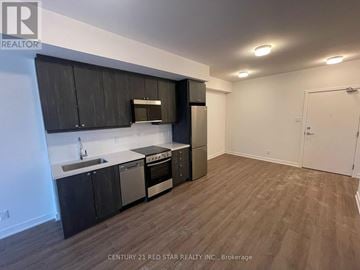 Clarington (Bowmanville) condo for rent - A kitchen with black cabinets and stainless steel appliances.