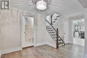 Toronto (York University Heights) apartment for rent - A white interior room with a staircase and a chandelier.