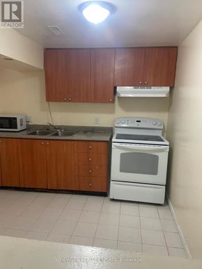 Mississauga (Hurontario) apartment for rent - A kitchen with a white oven and microwave.