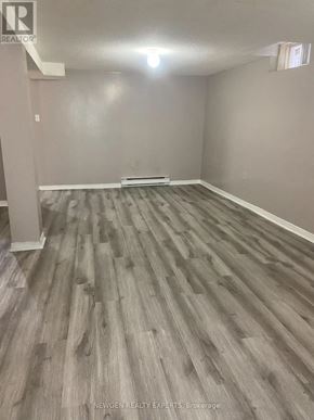 Mississauga (Hurontario) apartment for rent - A room with wooden flooring and a white column in the corner.