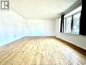 Lasalle apartment for rent - A room with wooden flooring and a window on the right side.