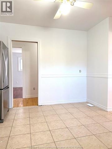 Lasalle apartment for rent - A kitchen with a refrigerator and a doorway leading to another room.