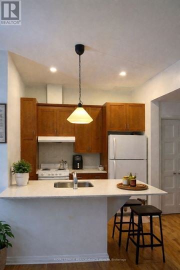Casselman apartment for rent - A kitchen with a white countertop and wooden cabinets.