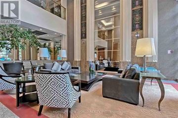 Toronto (Bay Street Corridor) condo for rent - A living room with a glass table and a grey sofa.