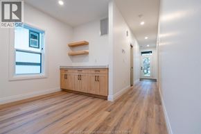 Windsor duplex for rent - A long hallway with white walls and wood flooring.