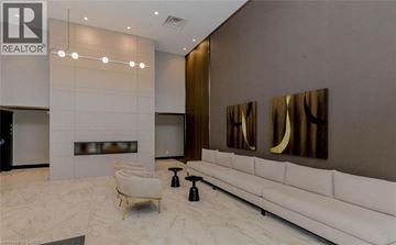 Milton condo for rent - A modern living room with a white sofa and a fireplace.