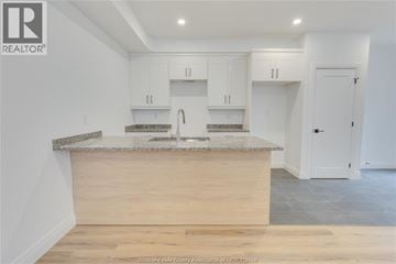 Windsor duplex for rent - A kitchen with a counter and cabinets.