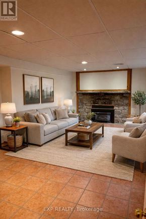 Caledon (Cheltenham) apartment for rent - A living room with a couch, a chair, a coffee table, and a fireplace.