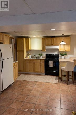 Caledon (Cheltenham) apartment for rent - A kitchen with tile flooring and wooden cabinets.