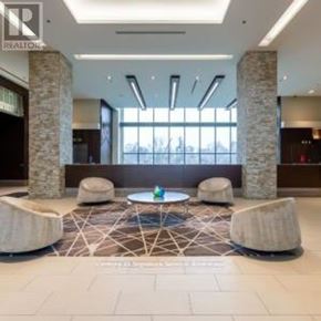Toronto (Thorncliffe Park) house for rent - A spacious lobby with a stone pillar and a patterned rug.