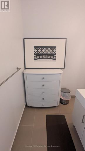 Toronto (Thorncliffe Park) house for rent - A waiting area with brown couches and a wooden table.