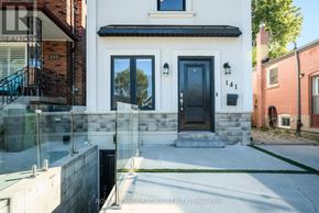 Toronto (Birchcliffe-Cliffside) apartment for rent - A modern house with a black front door and a glass railing.