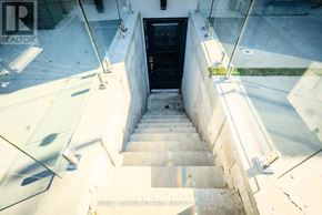 Toronto (Birchcliffe-Cliffside) apartment for rent - A set of stairs with glass railings leading to a dark door.